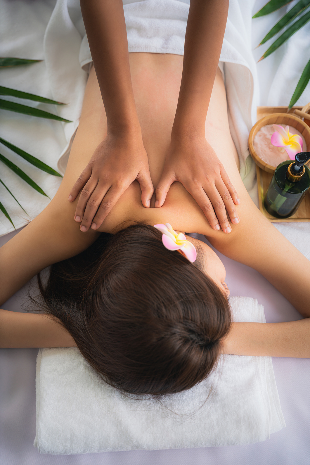 woman getting spa body massage treatment at beauty spa salon.